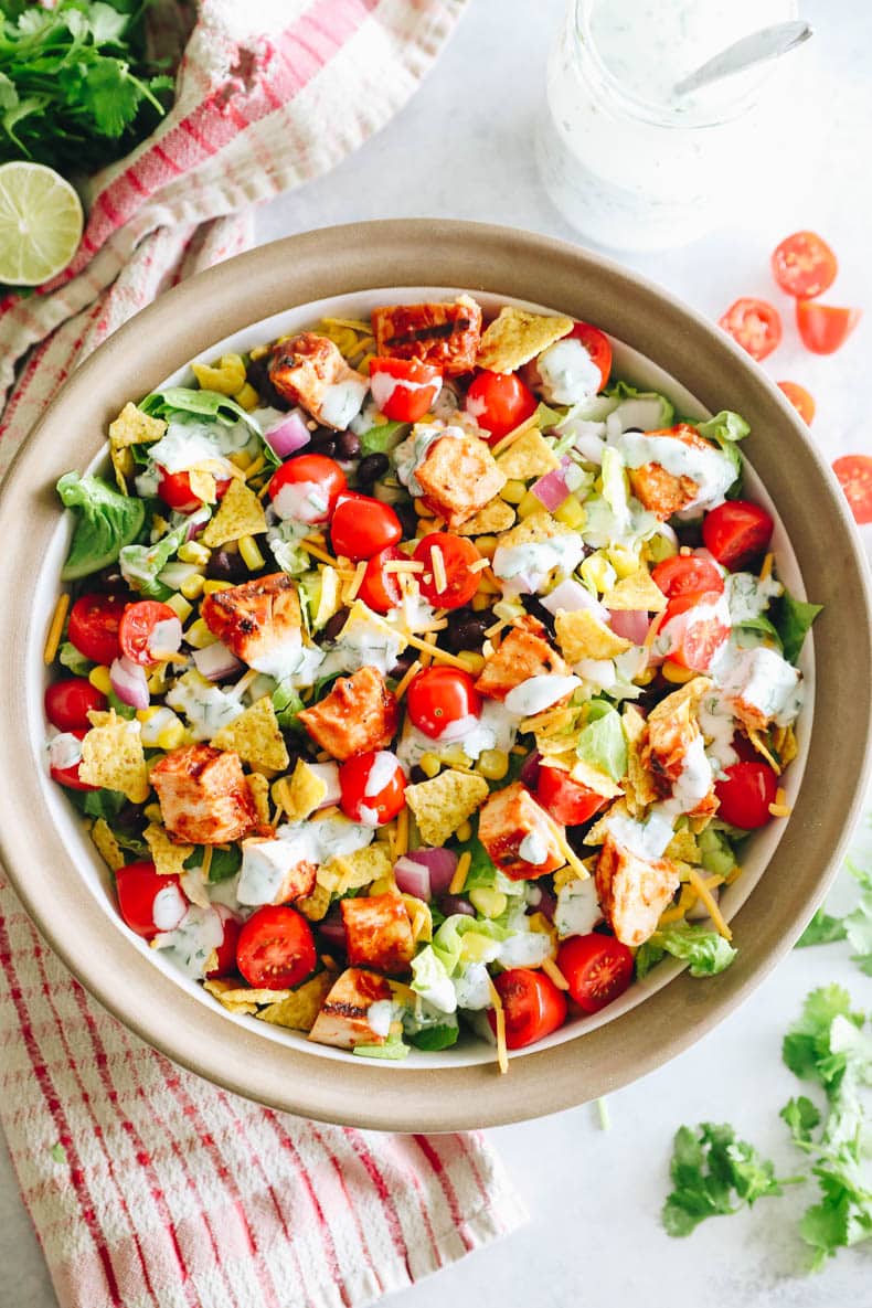 overhead image of BBQ chicken salad in a large serving bowl with greek yogurt ranch dressing.