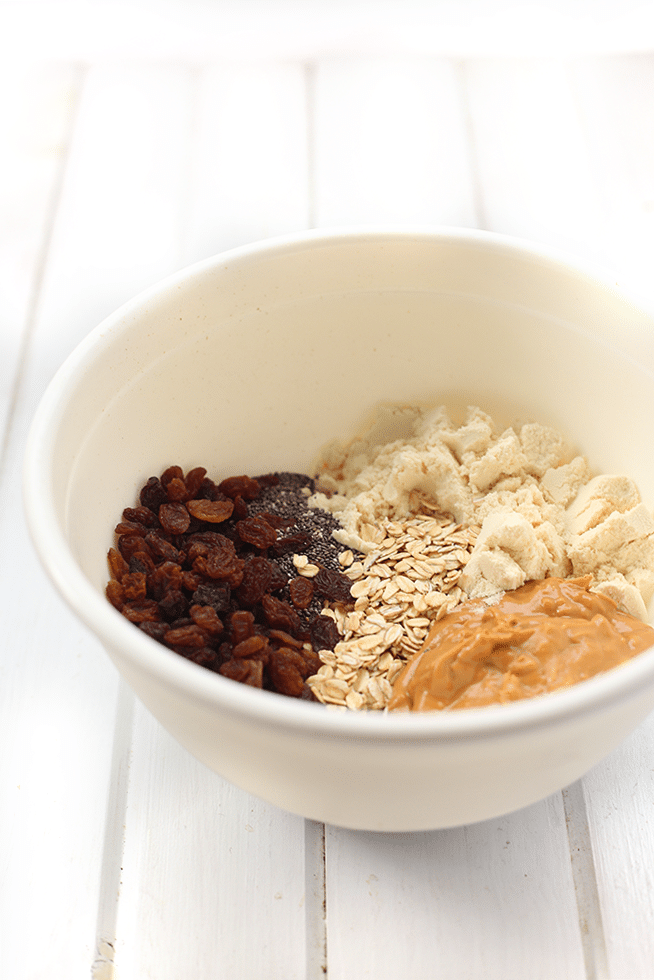 Ingredients for protein balls mixed in a white bowl