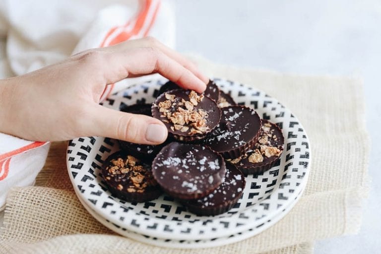 Switch up your Peanut Butter Cup game with these Tahini Butter Cups with Honey Candied Cereal sprinkled on top for a sweet treat with a twist. This delicious chocolate dessert recipe is sweetened entirely with honey for a healthier swap! #tahini #tahinibuttercups