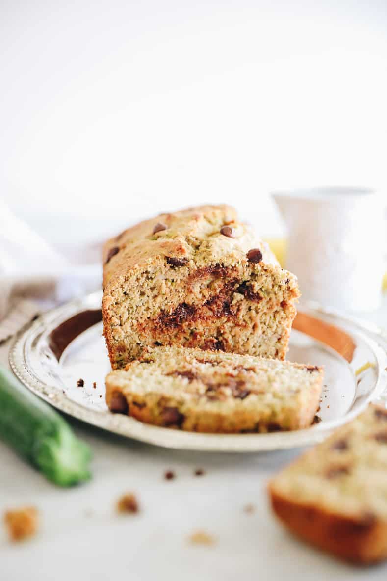 healthy zucchini bread sliced on a silver platter.