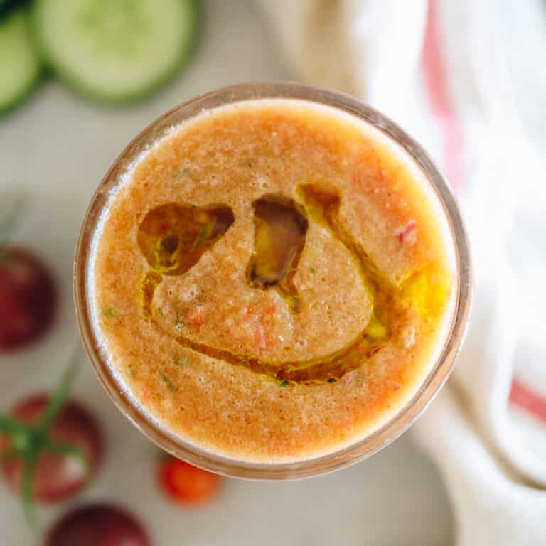 Overhead shot of a glass of tomato gazpacho.