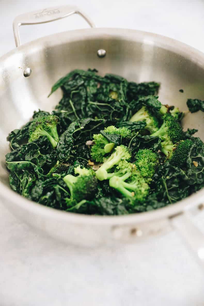 Cooked broccoli and kale in a pot for buddha bowls.