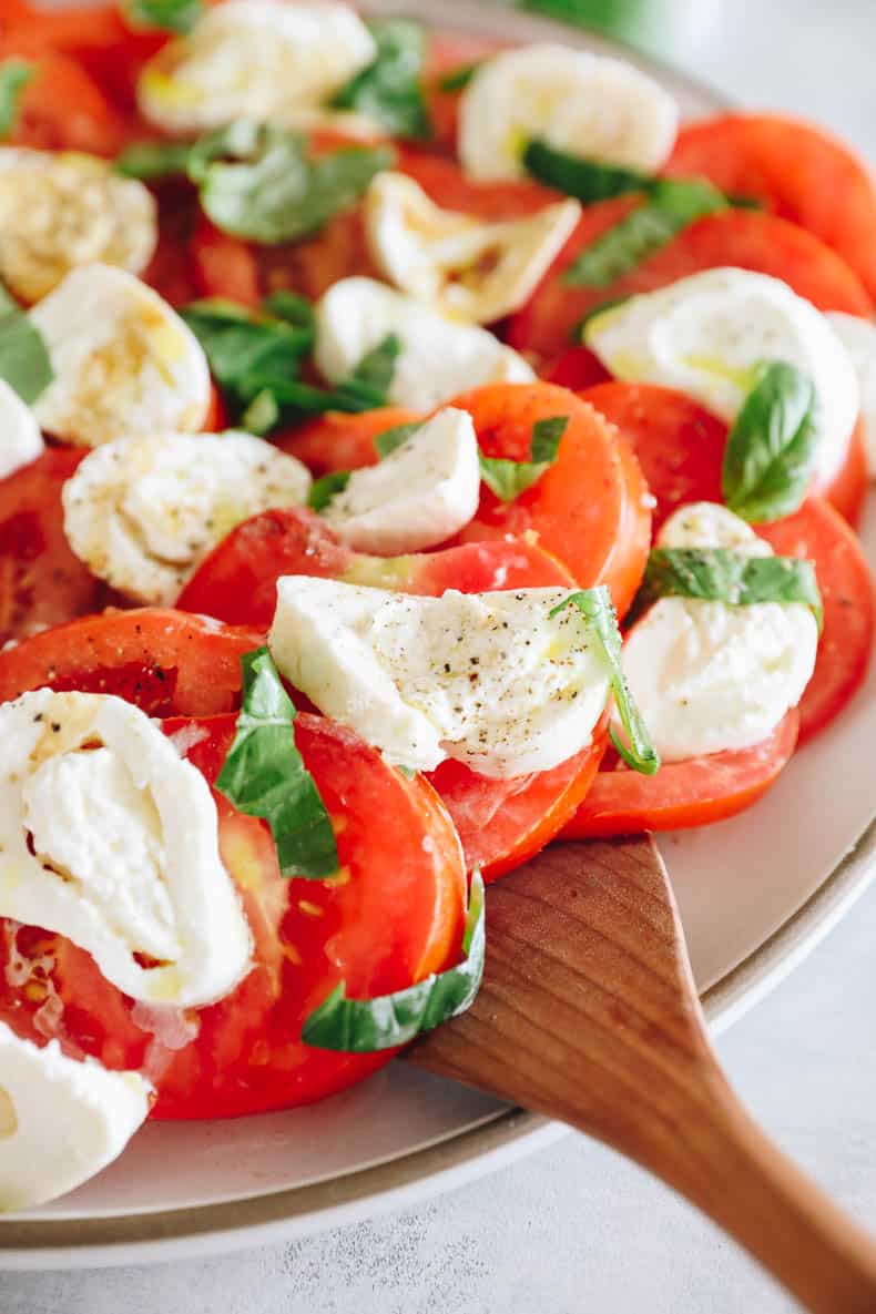 tomato burrata salad on a large serving dish.