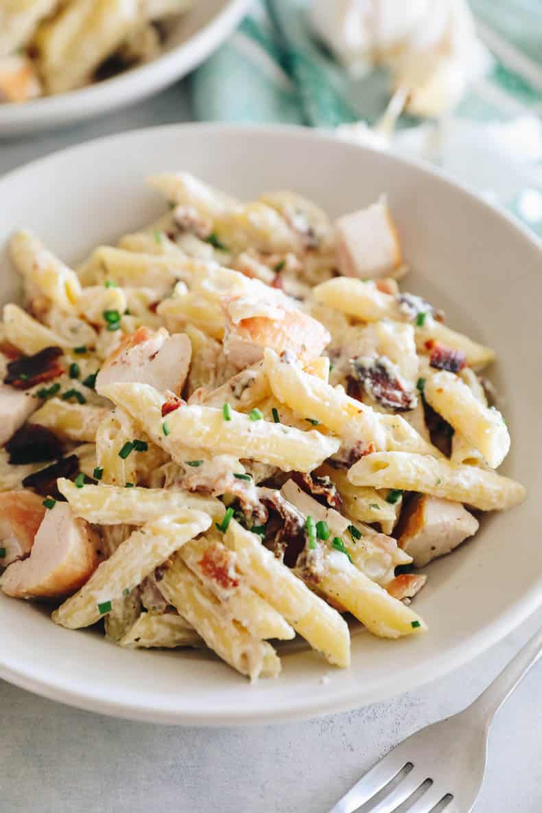 chicken bacon ranch pasta in a shallow white bowl.