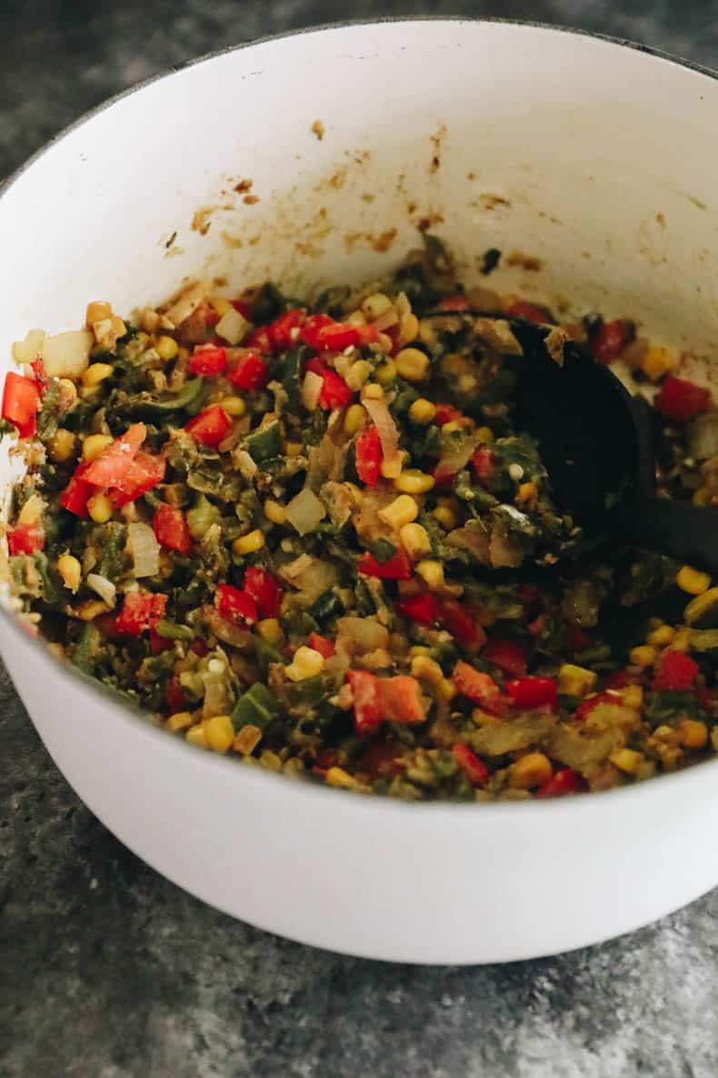 Base for chicken poblano soup in a white dutch oven.