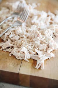 shredded chicken on a cutting board