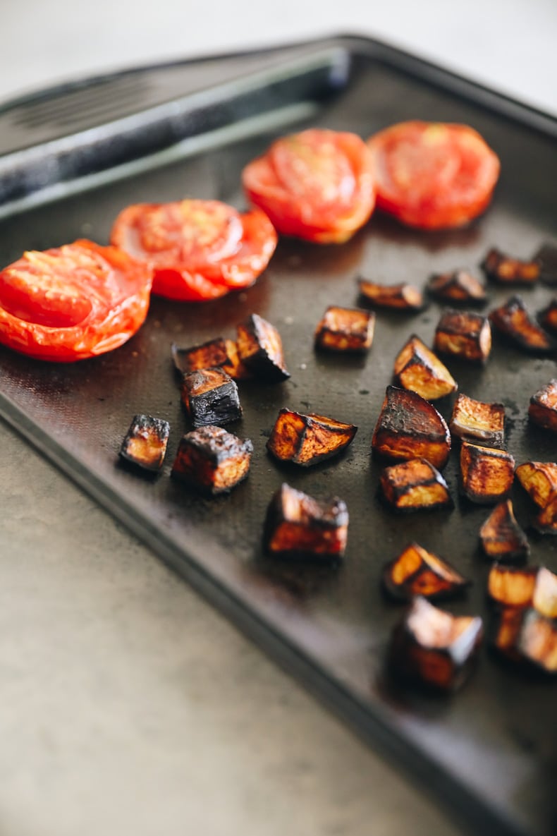 Roasted eggplant and tomatoes on a baking sheet