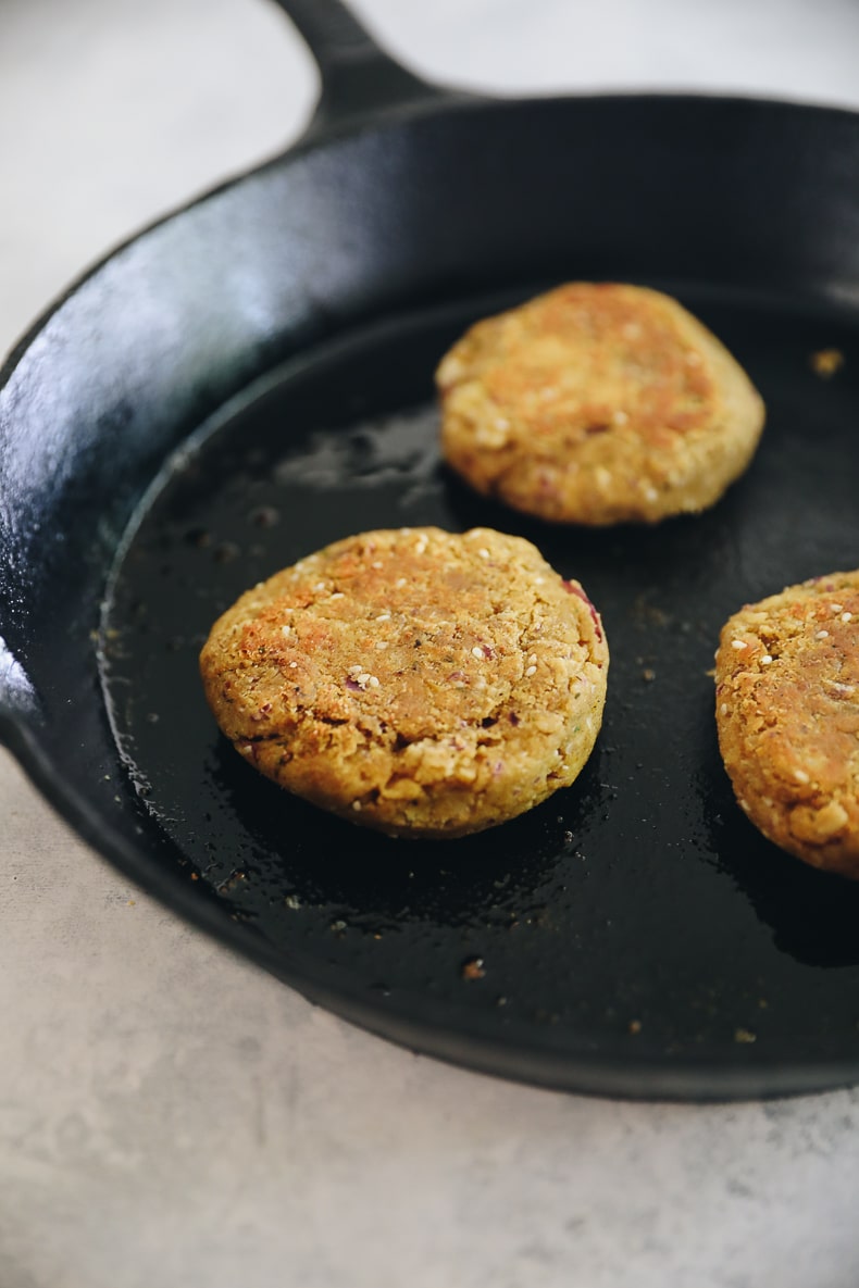 cooked falafel burgers on a cast-iron skillet