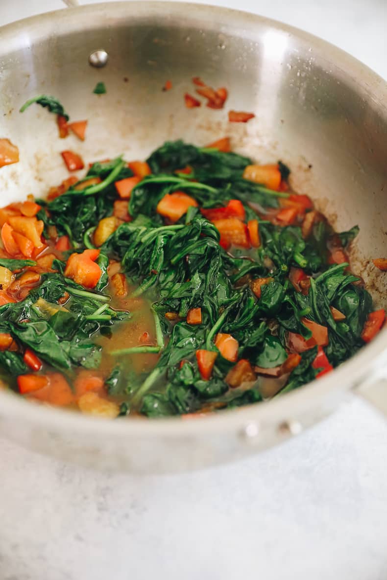 cooked bell pepper and spinach in a pan.