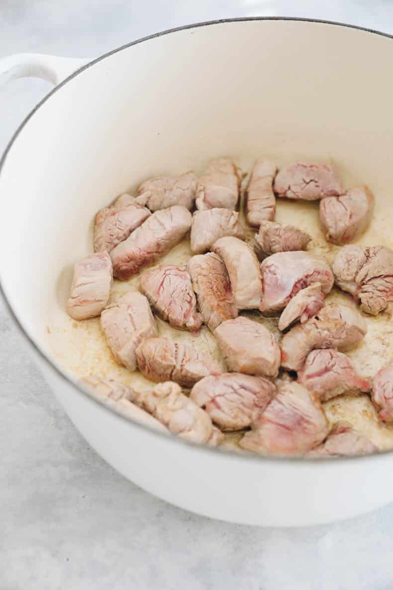 browning pork tenderloin in a dutch oven.