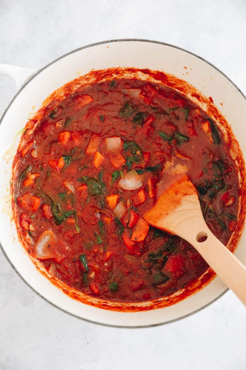 Overhead photograph of a recipe for pasta sauce for kids in a white dutch oven pot.