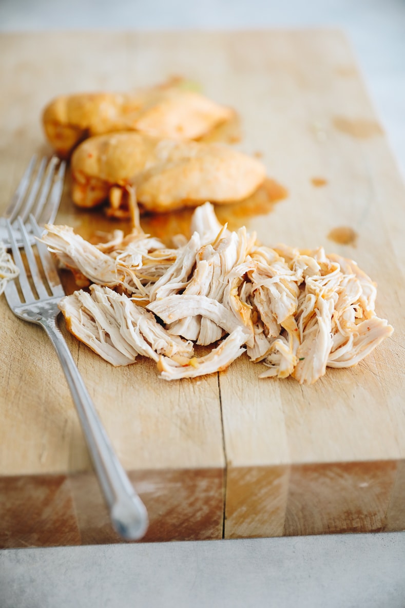 shredded chicken on a cutting board.