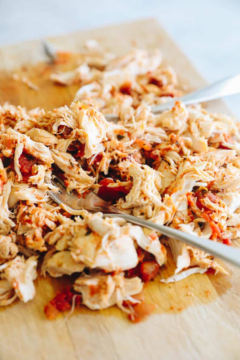 Shredded Salsa Chicken on a cutting board.