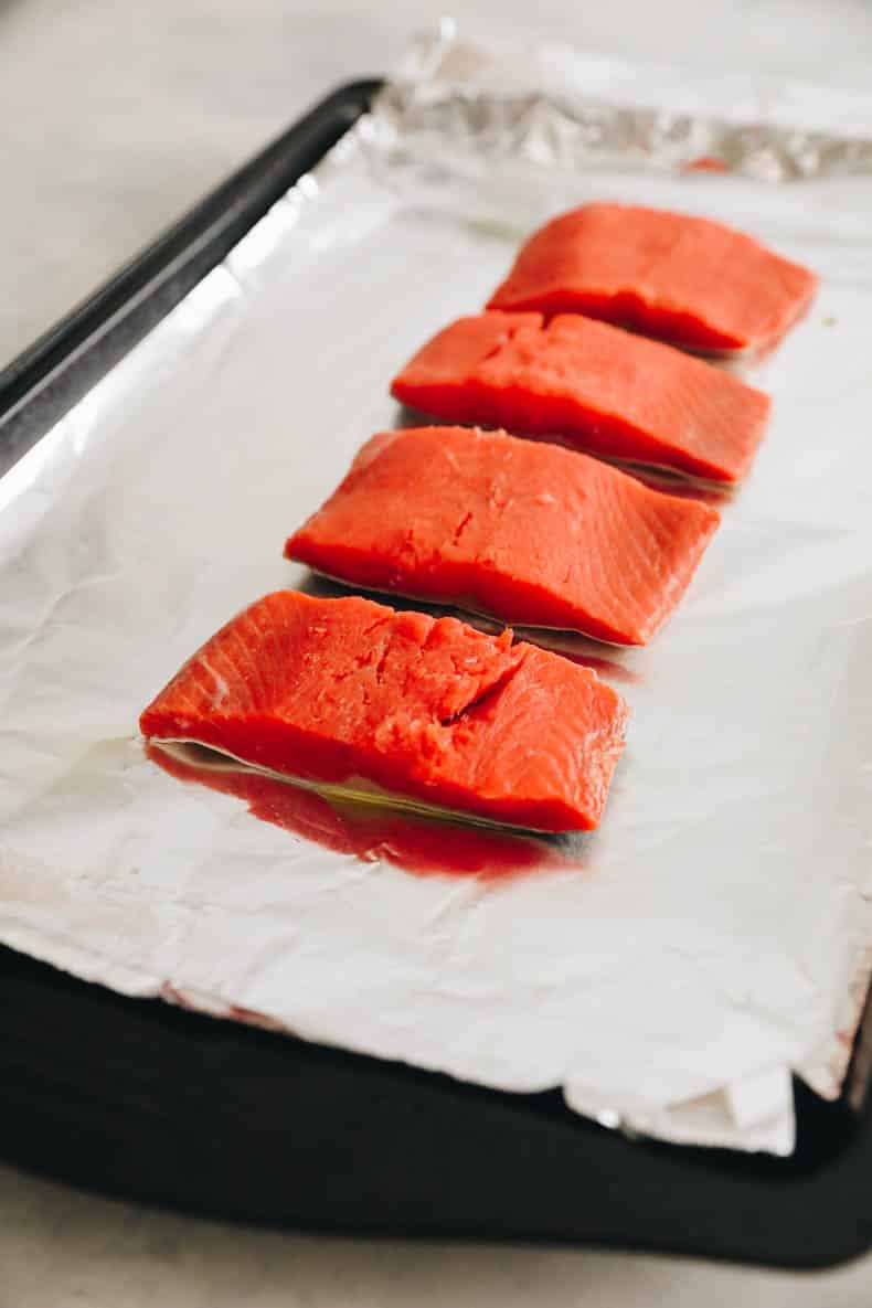 fresh salmon on a baking sheet lined with tinfoil