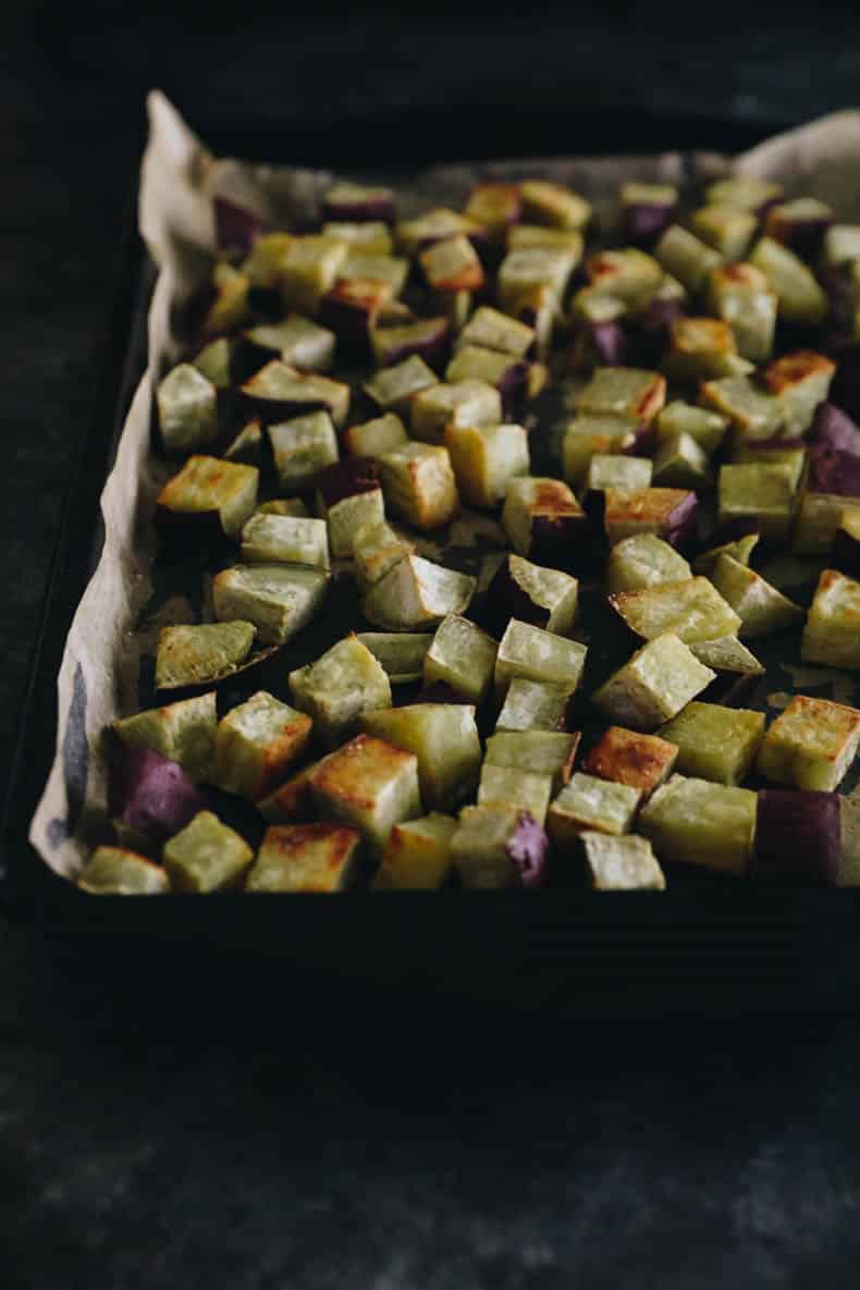 cubed and roasted Japanese sweet potato on a sheet pan.