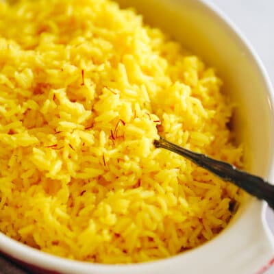 Close up shot of saffron rice in a serving dish.