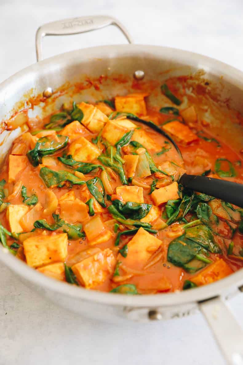 yellow tofu curry cooked in a pot.