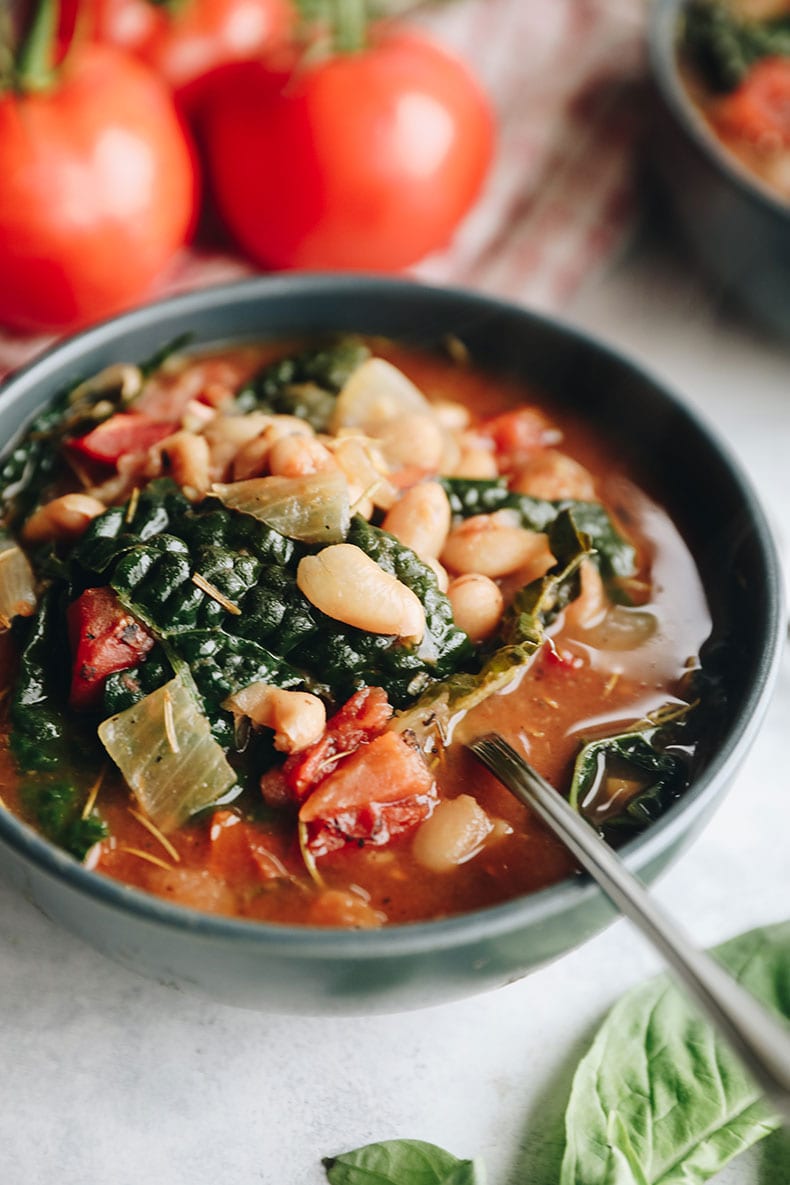 tuscan white bean soup in a blue bowl.