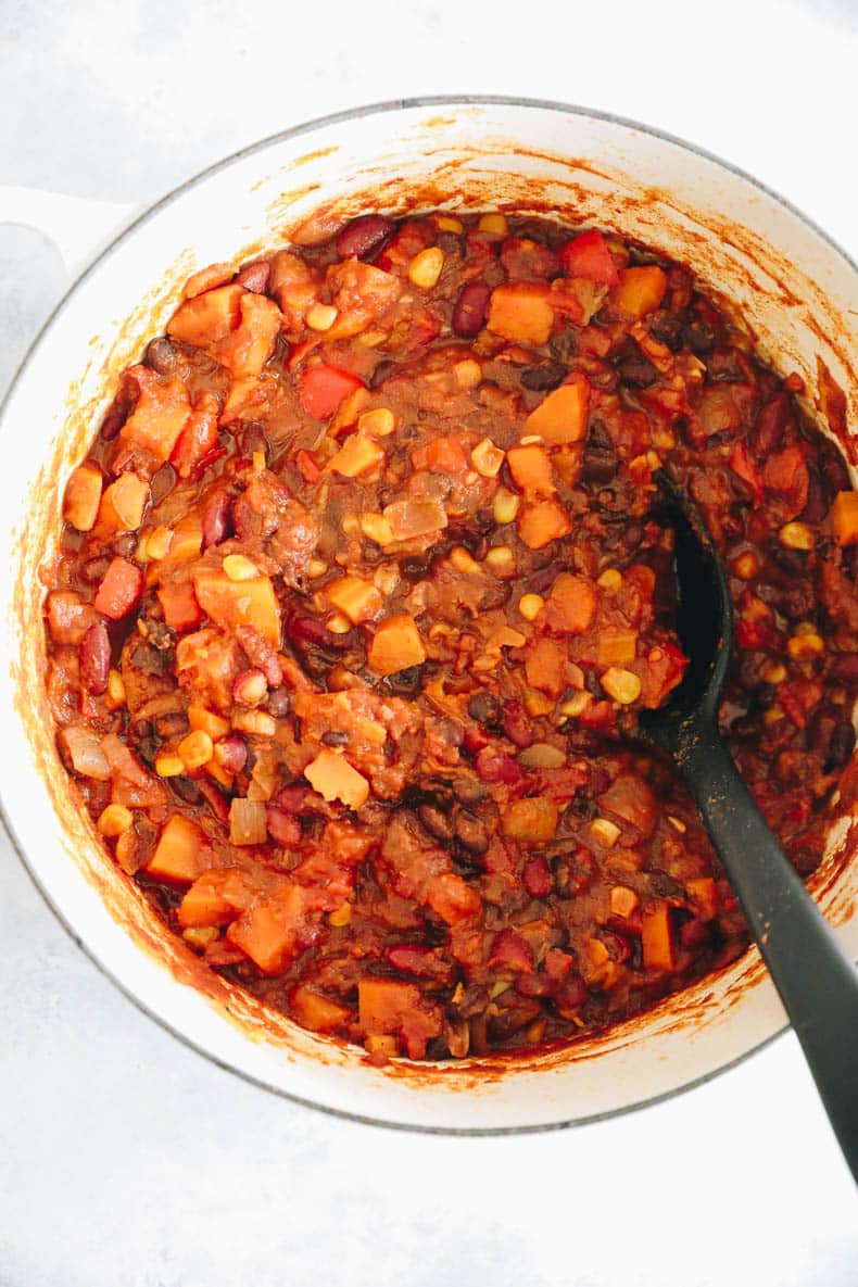 Cooked veggie chili recipe in a large white dutch oven.